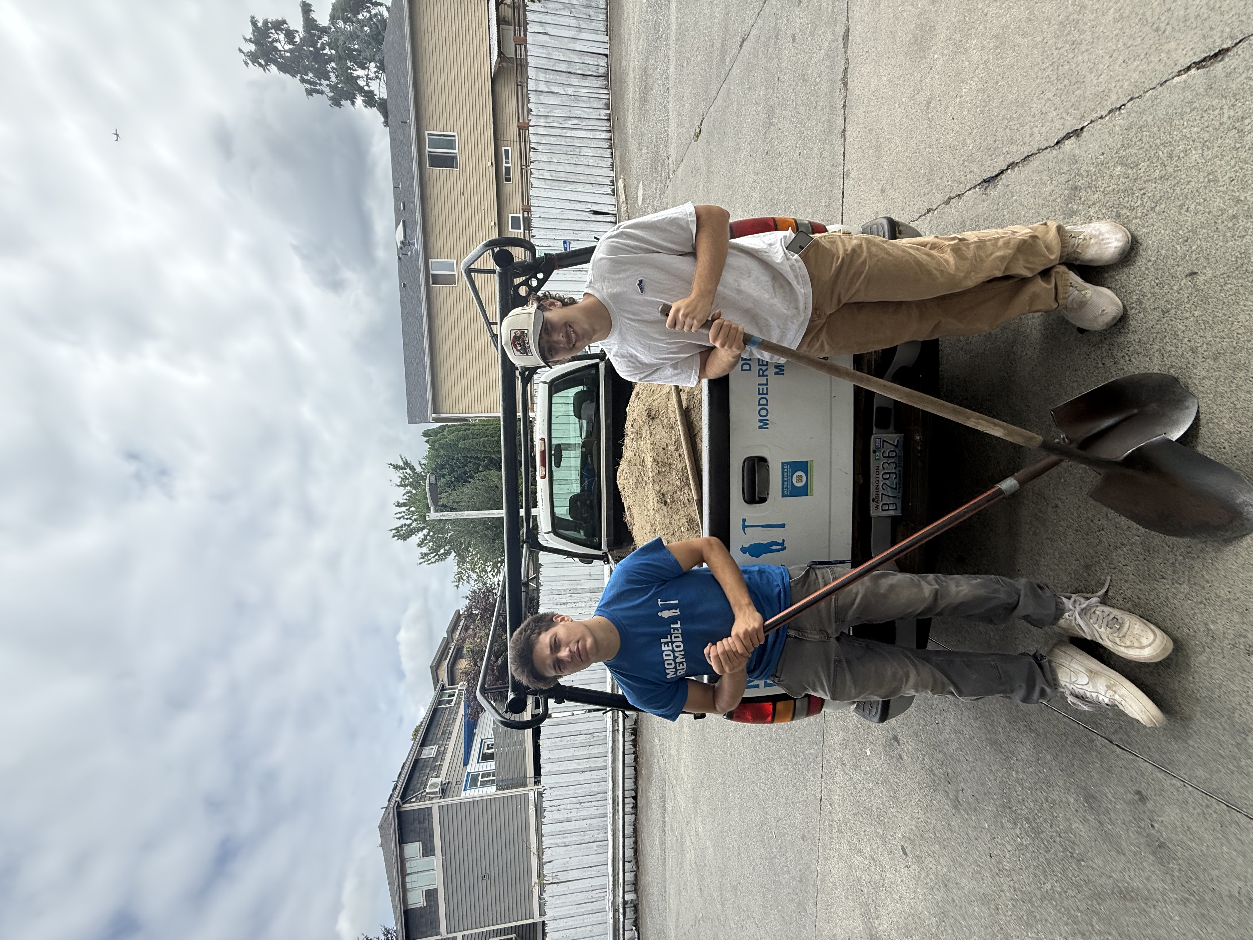 GL Hauling crew standing with shovels in front of a loaded hauling truck