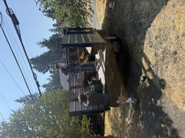GL Hauling team loading debris onto the dump truck at a job site